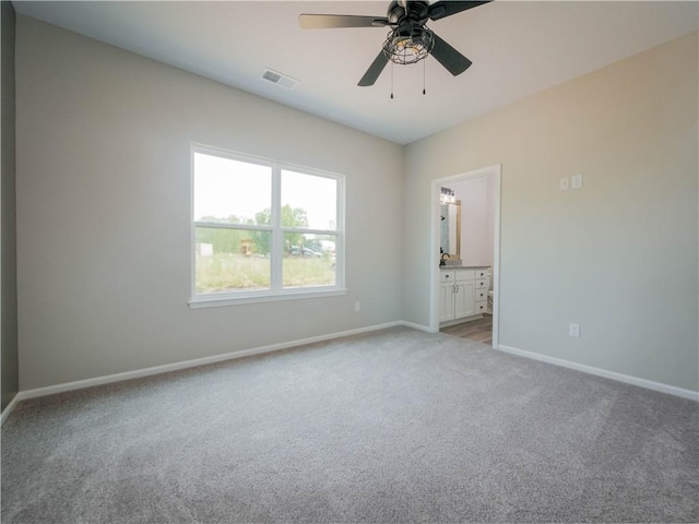 1313 N White Oaks Ln, Oak Grove, MO 64075 - spare room with light colored carpet, baseboards, and ceiling fan