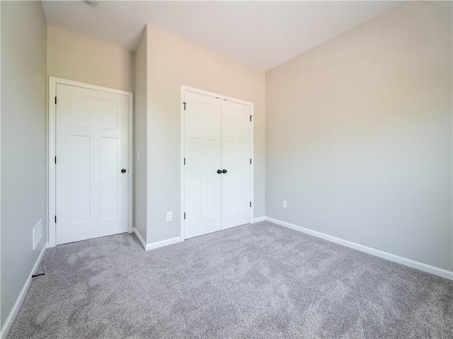 1313 N White Oaks Ln, Oak Grove, MO 64075 - unfurnished bedroom with carpet flooring, baseboards, and a closet