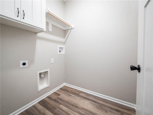 1313 N White Oaks Ln, Oak Grove, MO 64075 - laundry area featuring cabinet space, wood finished floors, hookup for an electric dryer, baseboards, and washer hookup