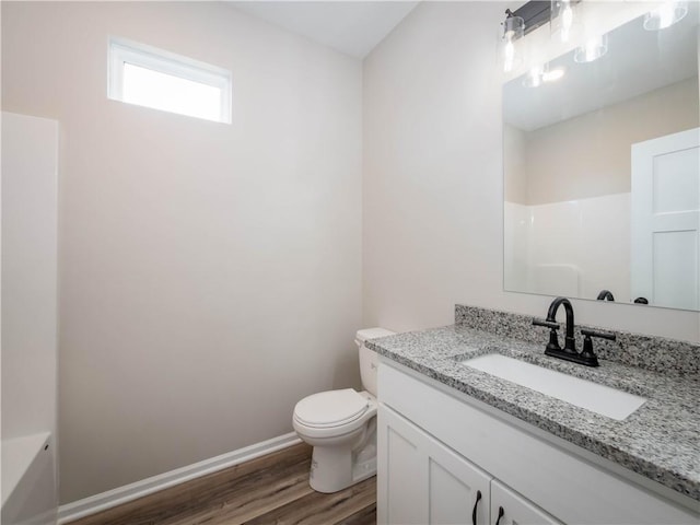 1313 N White Oaks Ln, Oak Grove, MO 64075 - bathroom with wood finished floors, toilet, baseboards, vanity, and a shower