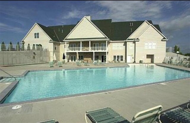 1313 N White Oaks Ln, Oak Grove, MO 64075 - community pool with a patio and fence