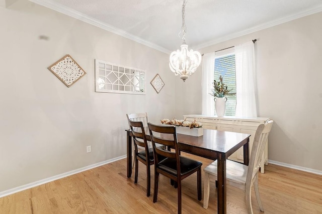 14263 W 129th Ter, Olathe, KS 66062 - dining room featuring a chandelier, light wood finished floors, crown molding, and baseboards