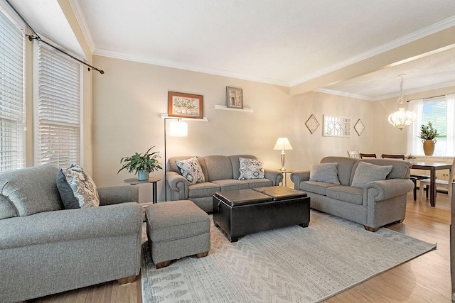 14263 W 129th Ter, Olathe, KS 66062 - living area with a chandelier, wood finished floors, and ornamental molding