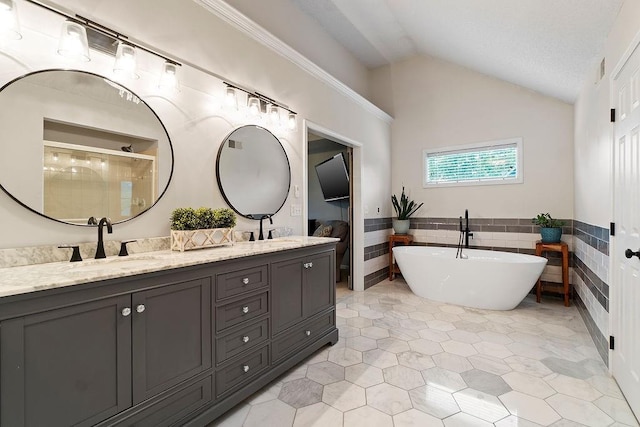 14263 W 129th Ter, Olathe, KS 66062 - full bath with double vanity, vaulted ceiling, a freestanding tub, tile patterned flooring, and a stall shower