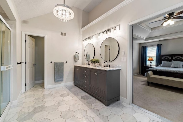 14263 W 129th Ter, Olathe, KS 66062 - ensuite bathroom with double vanity, a chandelier, a ceiling fan, vaulted ceiling, and baseboards