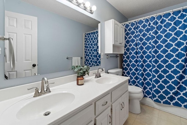 14263 W 129th Ter, Olathe, KS 66062 - full bathroom featuring toilet, double vanity, tile patterned flooring, a textured ceiling, and curtained shower