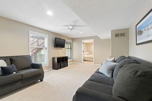 14263 W 129th Ter, Olathe, KS 66062 - living room featuring light carpet, a ceiling fan, a textured ceiling, baseboards, and recessed lighting
