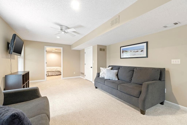 14263 W 129th Ter, Olathe, KS 66062 - living area featuring light carpet, ceiling fan, baseboards, and a textured ceiling