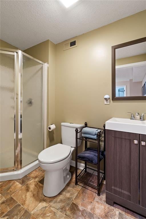 14263 W 129th Ter, Olathe, KS 66062 - full bath with vanity, toilet, a shower stall, a textured ceiling, and stone finish flooring