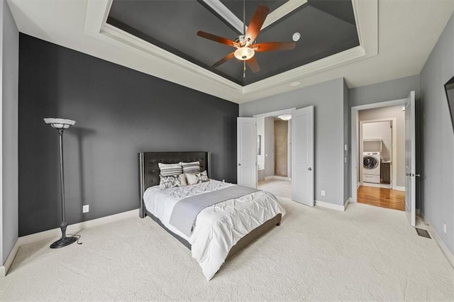 16456 Cody St, Overland Park, KS 66062 - bedroom featuring a tray ceiling, light carpet, washer / dryer, baseboards, and ornamental molding