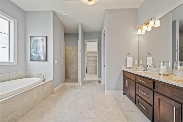 16456 Cody St, Overland Park, KS 66062 - full bathroom with healthy amount of natural light, a bath, tiled shower, and vanity