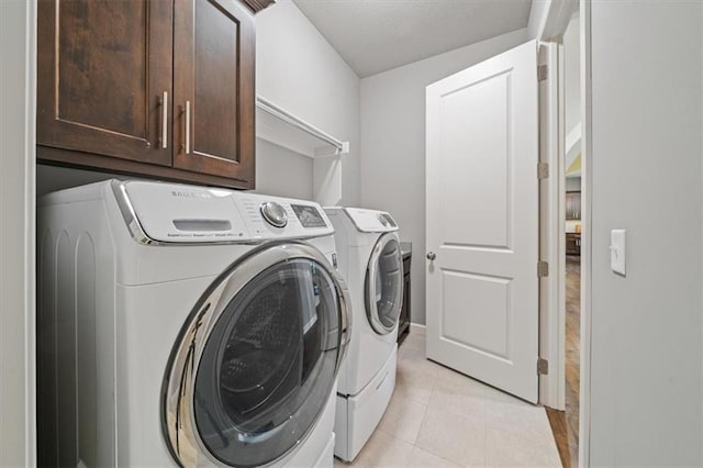16456 Cody St, Overland Park, KS 66062 - washroom with washer and dryer, cabinet space, and light tile patterned floors