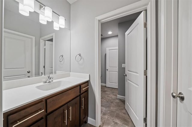 16456 Cody St, Overland Park, KS 66062 - bathroom with vanity, baseboards, recessed lighting, and stone finish floors