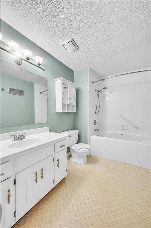 bathroom featuring vanity, toilet,  shower combination, and a textured ceiling