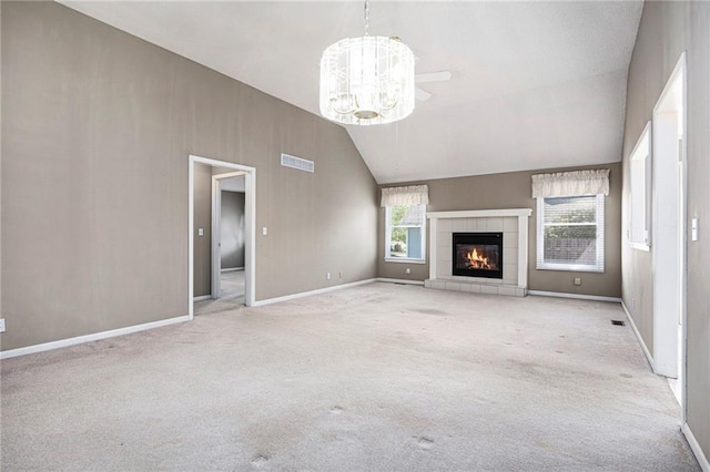 7001 W 157th Ter, Overland Park, KS 66223 - unfurnished living room with vaulted ceiling, carpet flooring, a fireplace, a chandelier, and baseboards