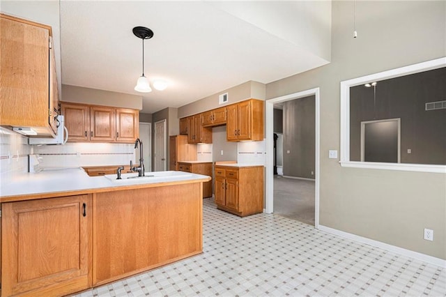 7001 W 157th Ter, Overland Park, KS 66223 - kitchen with a peninsula, baseboards, light countertops, decorative backsplash, and brown cabinets