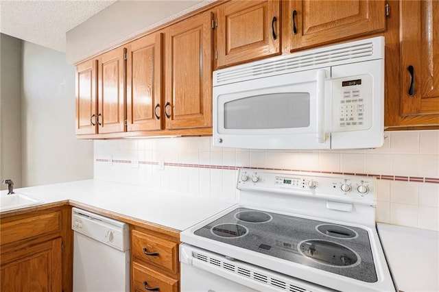 7001 W 157th Ter, Overland Park, KS 66223 - kitchen featuring white appliances, light countertops, decorative backsplash, brown cabinetry, and a textured ceiling
