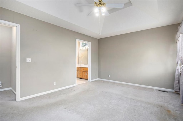 7001 W 157th Ter, Overland Park, KS 66223 - unfurnished bedroom featuring light carpet, baseboards, connected bathroom, and a ceiling fan