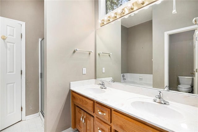 7001 W 157th Ter, Overland Park, KS 66223 - bathroom with toilet, double vanity, a stall shower, baseboards, and tile patterned floors