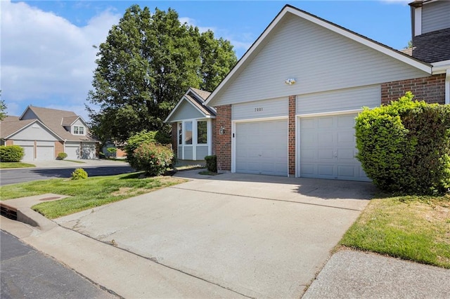 7001 W 157th Ter, Overland Park, KS 66223 - view of front facade with brick siding, an attached garage, and driveway