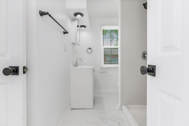 14213 S Haven Rd, Grandview, MO 64030 - bathroom featuring a shower, baseboards, marble look tile flooring, and vanity