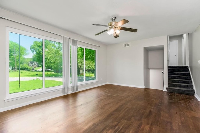 1924 N 75th Dr, Kansas City, KS 66112 - unfurnished living room with wood finished floors, a ceiling fan, baseboards, and stairway