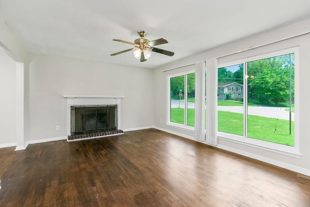 1924 N 75th Dr, Kansas City, KS 66112 - unfurnished living room with wood finished floors, a ceiling fan, a fireplace, and baseboards