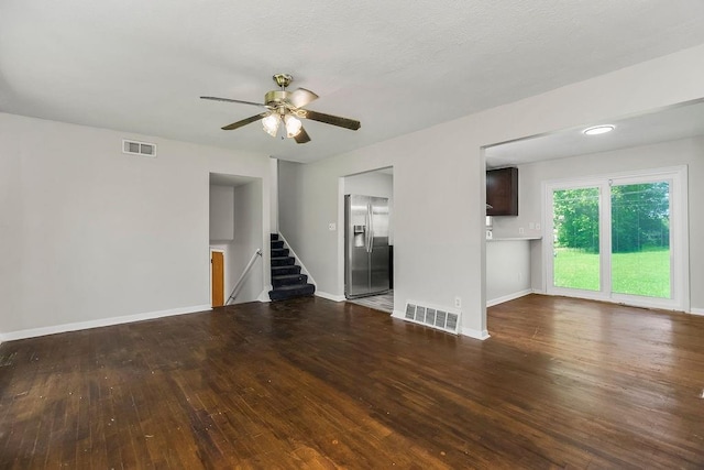 1924 N 75th Dr, Kansas City, KS 66112 - unfurnished living room with stairway, wood finished floors, baseboards, and a ceiling fan
