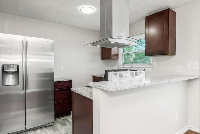 1924 N 75th Dr, Kansas City, KS 66112 - kitchen with stainless steel fridge, island exhaust hood, dark brown cabinets, a peninsula, and a textured ceiling