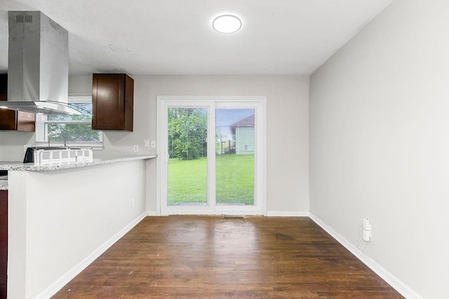 1924 N 75th Dr, Kansas City, KS 66112 - kitchen featuring island range hood, dark brown cabinets, dark wood-type flooring, and baseboards