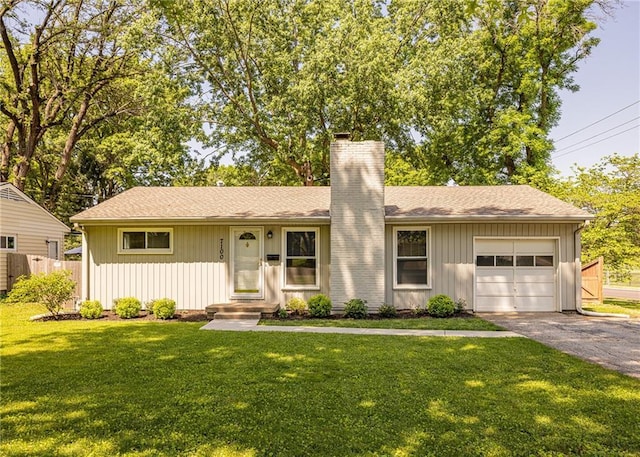 ranch-style home featuring a chimney, driveway, a garage, and board and batten siding