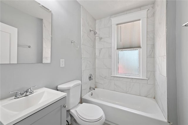 bathroom with vanity, toilet, and shower / bathtub combination