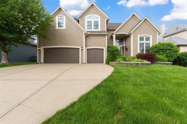 view of front of house with a garage, stucco siding, driveway, and a front lawn