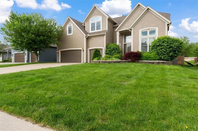 view of front of property with a garage, stucco siding, concrete driveway, and a front yard