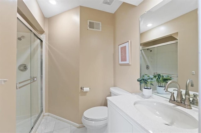 bathroom featuring toilet, a shower stall, and vanity