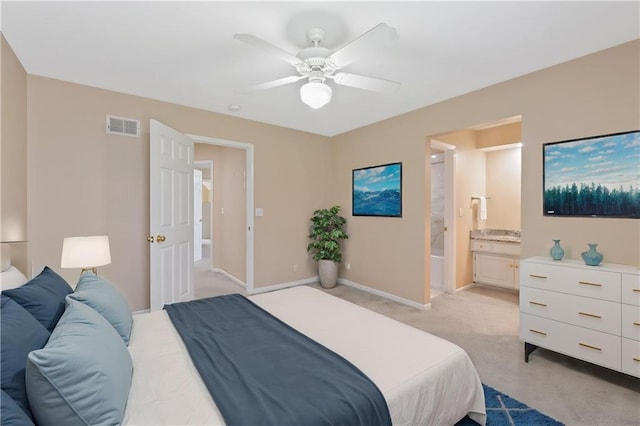 bedroom with light colored carpet, baseboards, ceiling fan, and ensuite bathroom