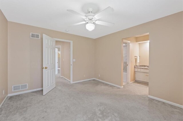 unfurnished bedroom with light colored carpet and baseboards