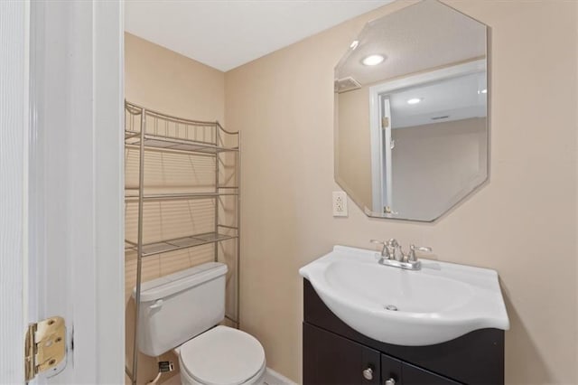 bathroom featuring toilet and vanity