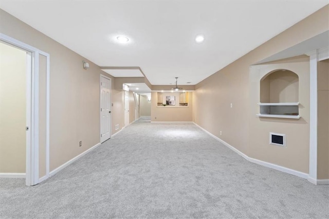 unfurnished living room with carpet, baseboards, and recessed lighting