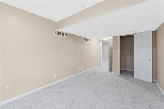 finished basement featuring light colored carpet and baseboards