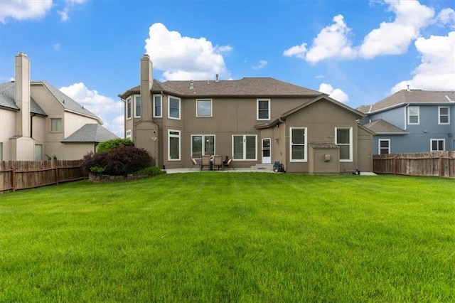 rear view of property featuring a patio area and a chimney