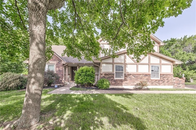 529 SW Windmill Ln, Lees Summit, MO 64082 - tudor-style house with brick siding and a front yard