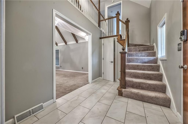 529 SW Windmill Ln, Lees Summit, MO 64082 - stairway with baseboards, high vaulted ceiling, and carpet flooring