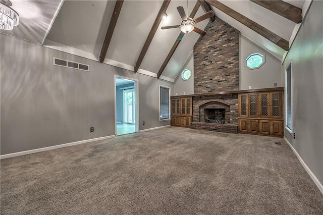 529 SW Windmill Ln, Lees Summit, MO 64082 - unfurnished living room with high vaulted ceiling, ceiling fan, beamed ceiling, carpet floors, and a brick fireplace