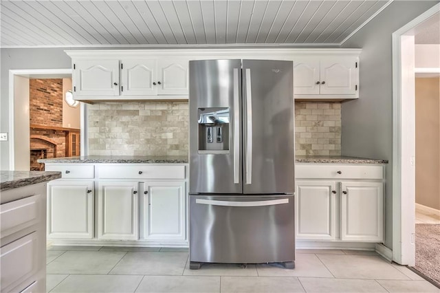 529 SW Windmill Ln, Lees Summit, MO 64082 - kitchen with stainless steel fridge with ice dispenser, white cabinetry, light stone counters, tasteful backsplash, and crown molding