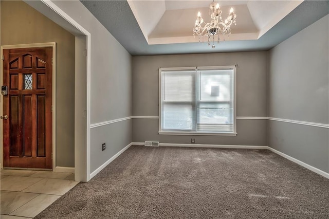 529 SW Windmill Ln, Lees Summit, MO 64082 - carpeted entrance foyer featuring a chandelier, a tray ceiling, baseboards, and tile patterned flooring