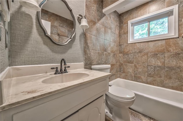 529 SW Windmill Ln, Lees Summit, MO 64082 - bathroom with toilet, vanity, tile walls, and bathtub / shower combination