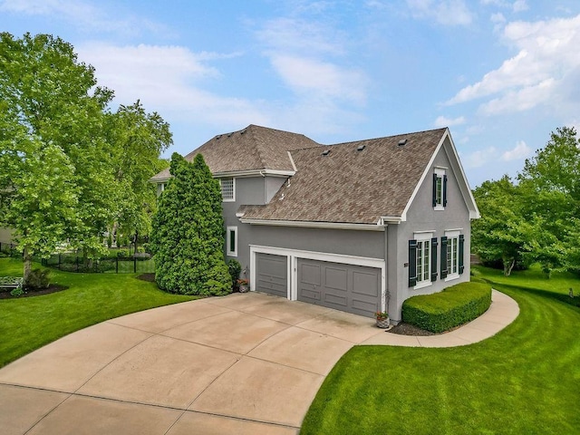 6104 W 144th St, Overland Park, KS 66223 - view of home's exterior featuring stucco siding, a garage, roof with shingles, and driveway