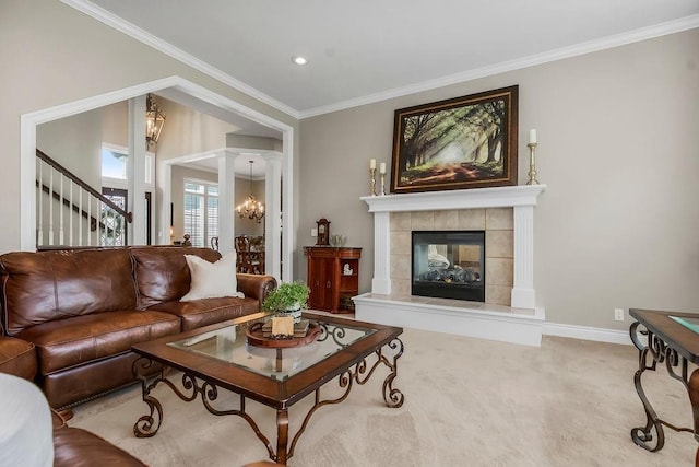 6104 W 144th St, Overland Park, KS 66223 - carpeted living room featuring ornamental molding, a tiled fireplace, baseboards, and decorative columns