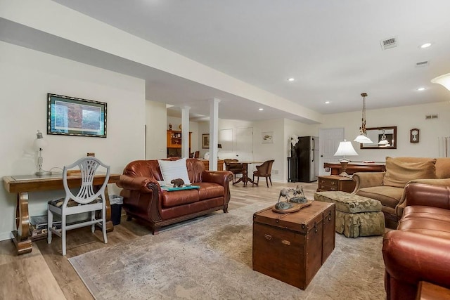 6104 W 144th St, Overland Park, KS 66223 - living area featuring light wood-style floors, decorative columns, baseboards, and recessed lighting
